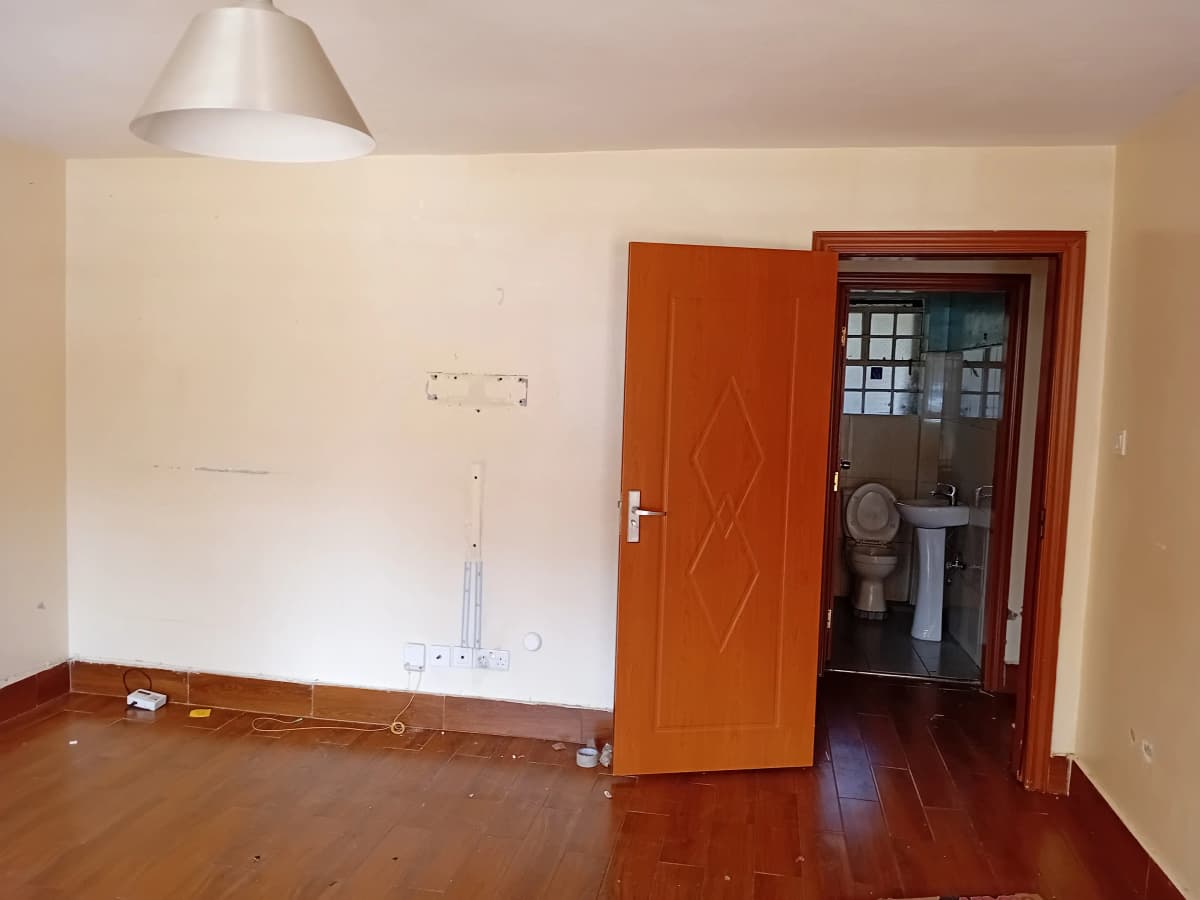Empty living room with wooden floors and pendant lighting