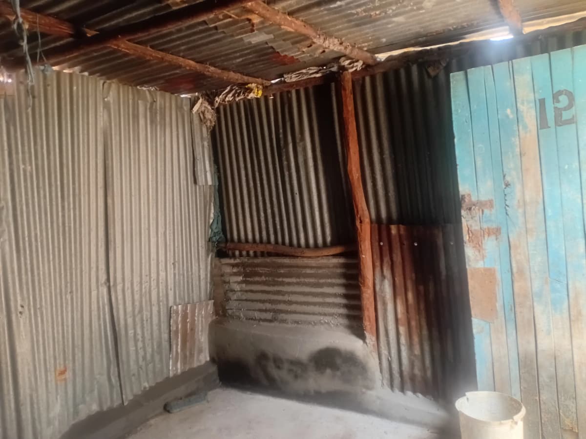 Corrugated metal structure, appears under construction or abandoned