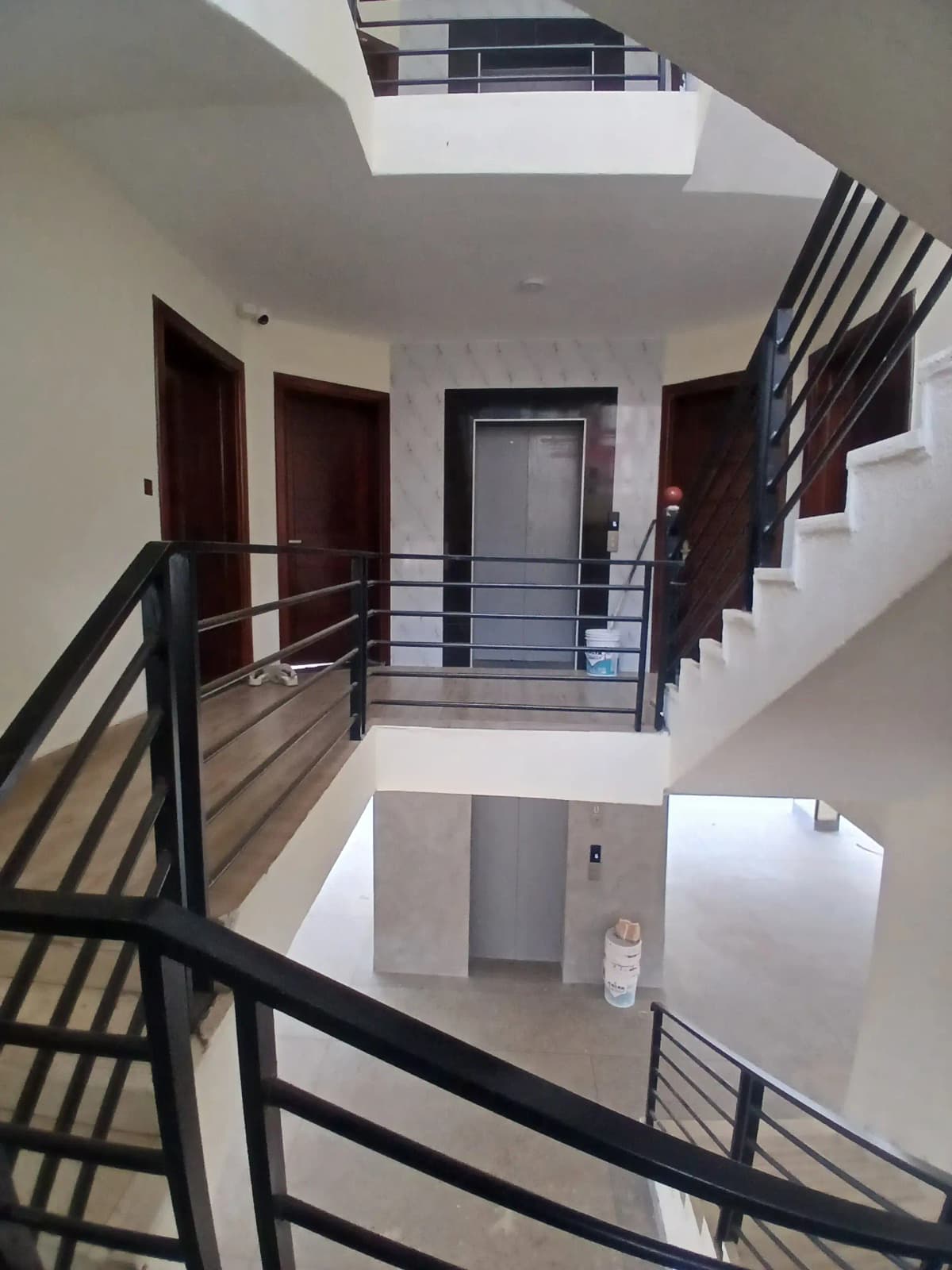 Multi-level interior atrium with metal railings and staircase