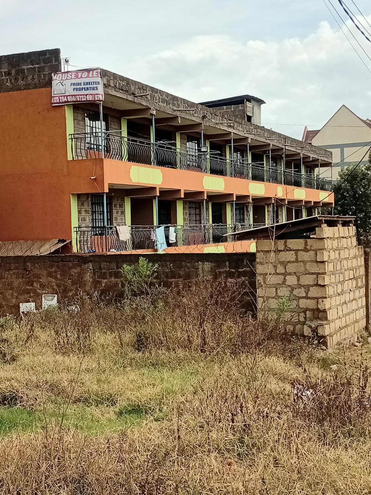Multi-story residential building with orange facade and balconies