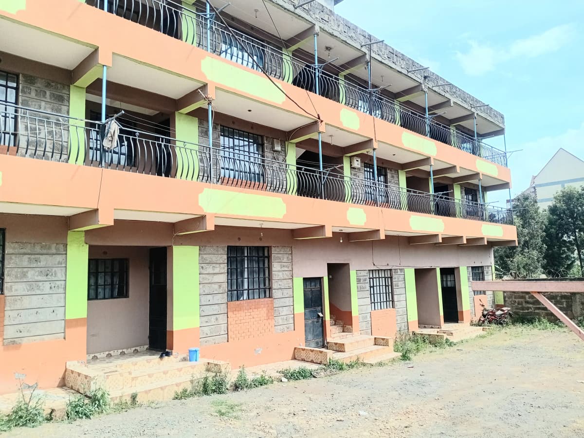 Multi-story residential building with orange and green facade