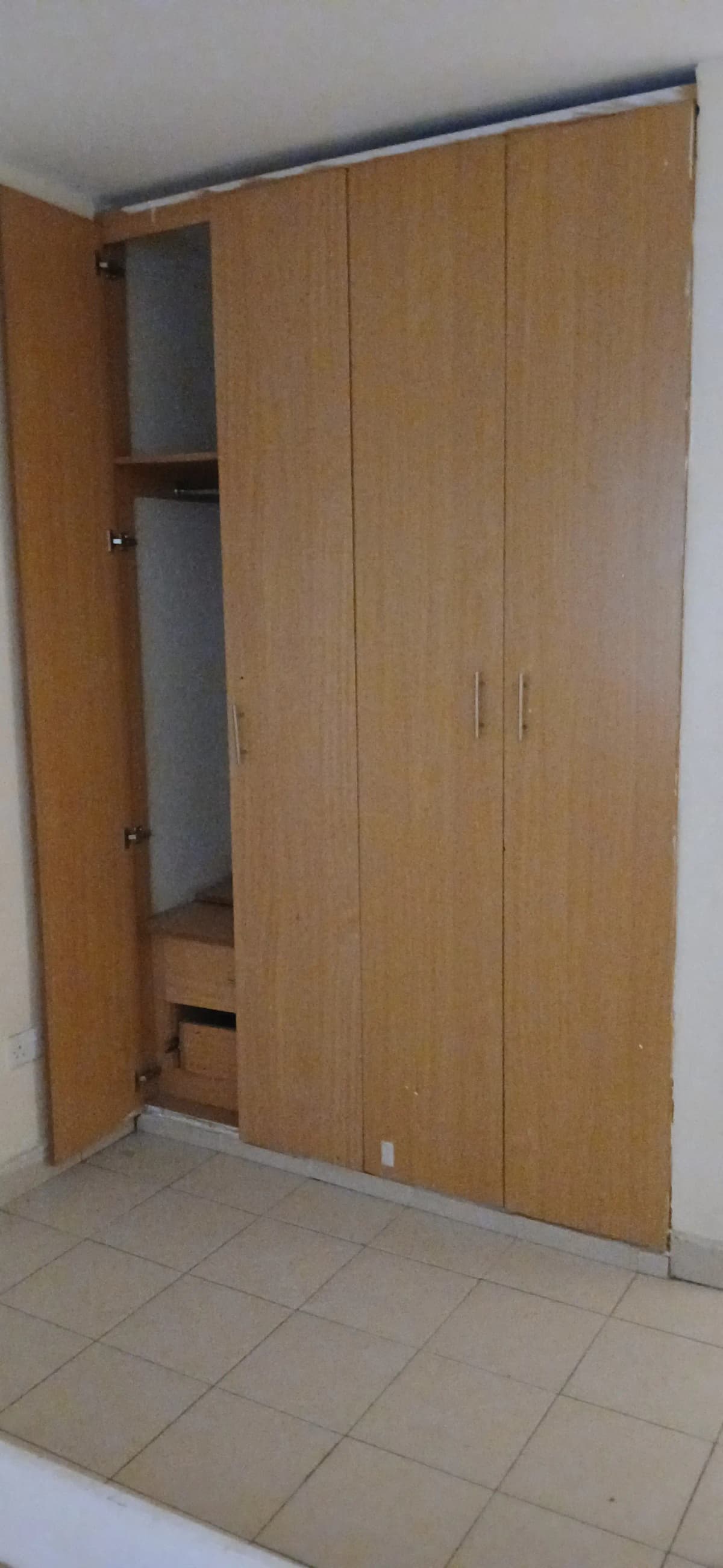 Bedroom with wooden built-in wardrobe and open doors