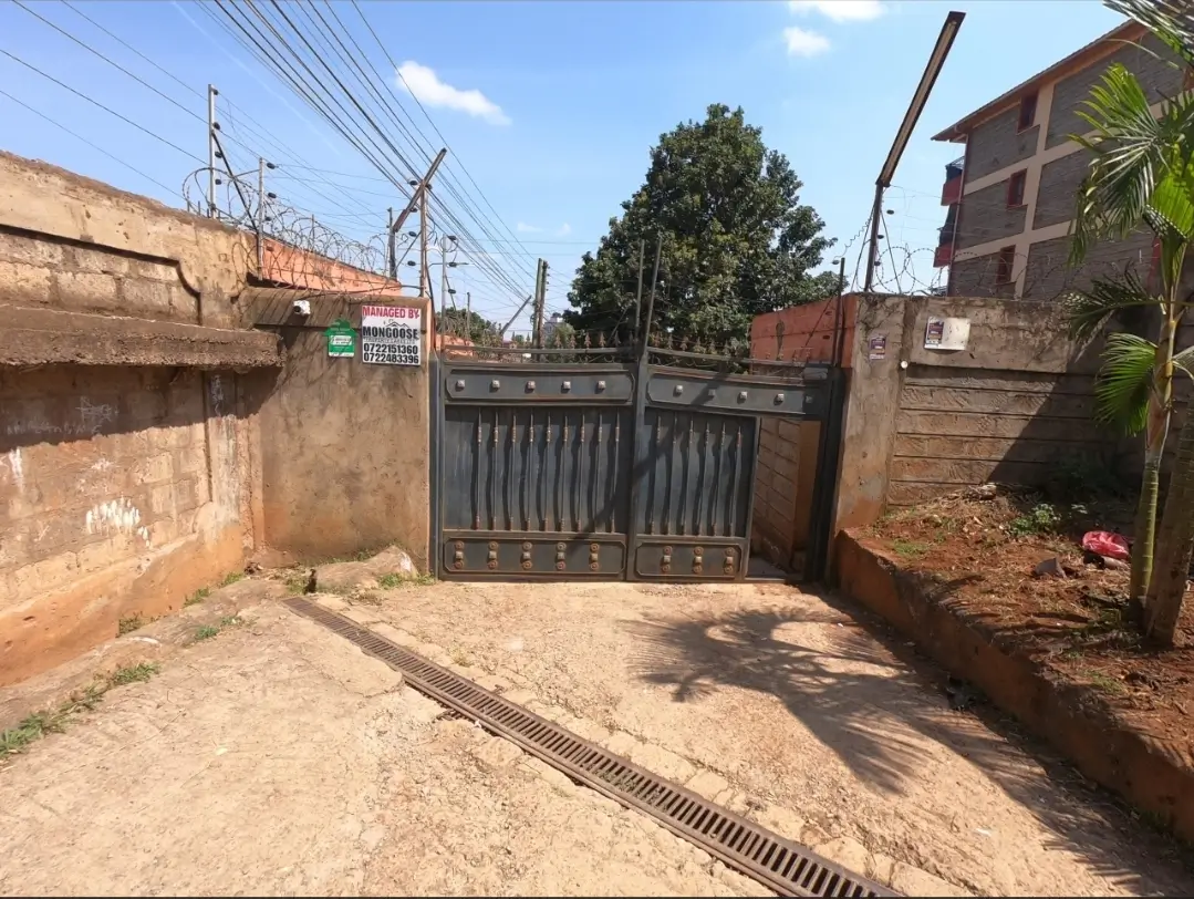 Secured compound parking area with metal gate entrance