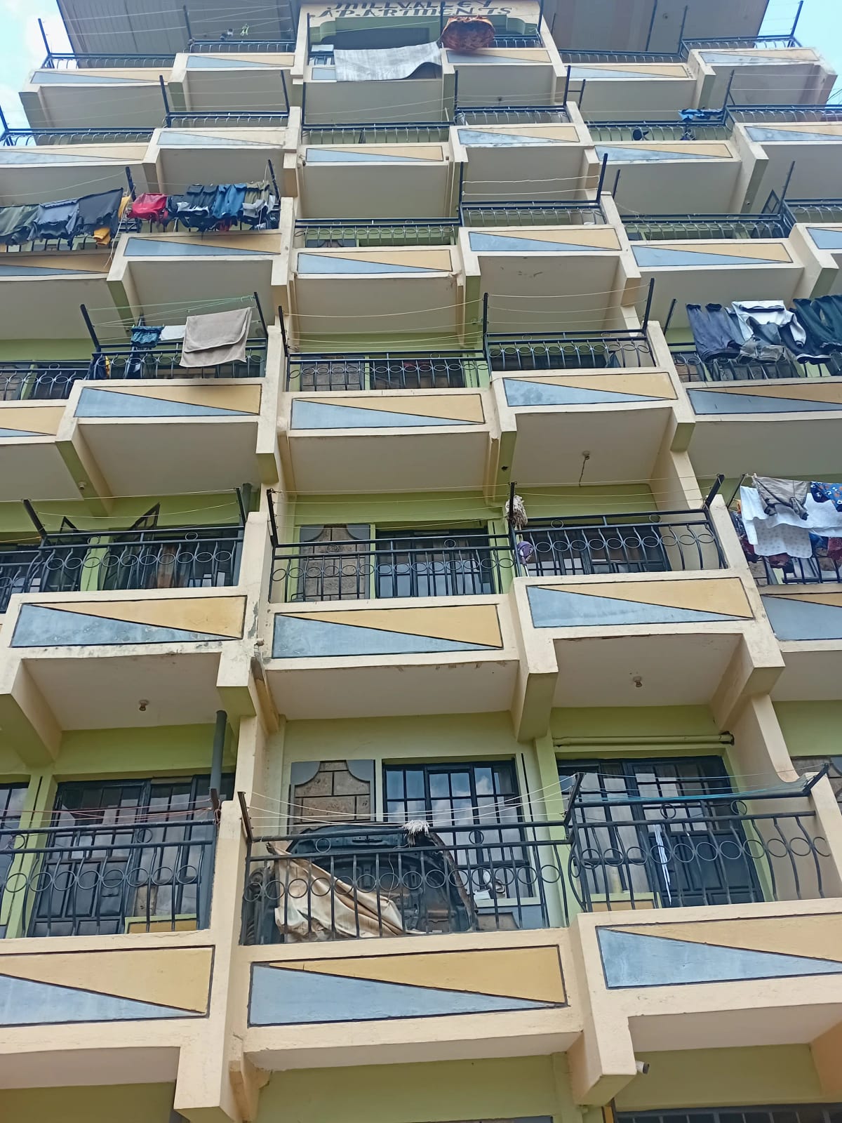 Multi-story residential building facade with balconies and railings