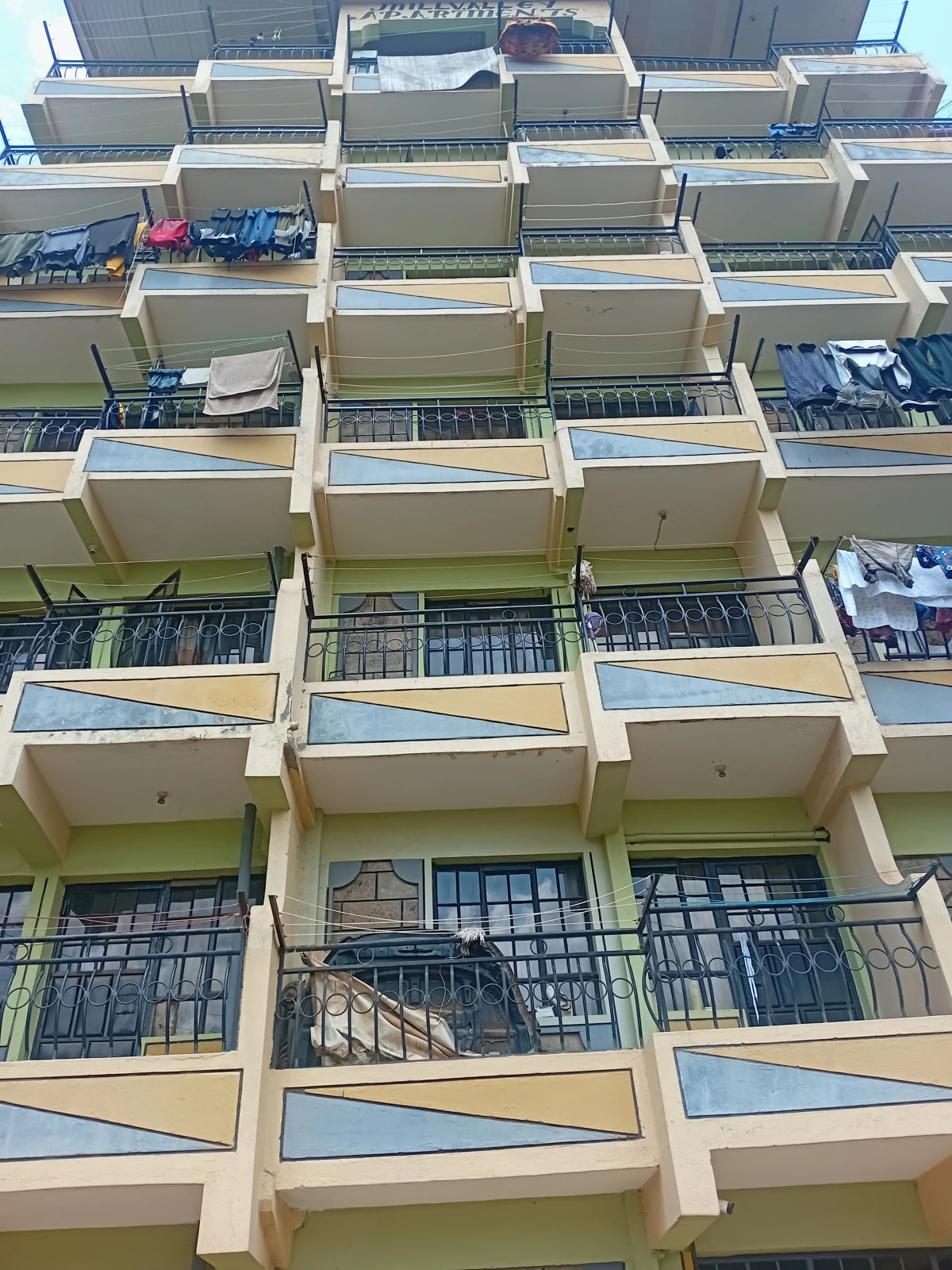 Multi-story residential building facade with balconies and railings