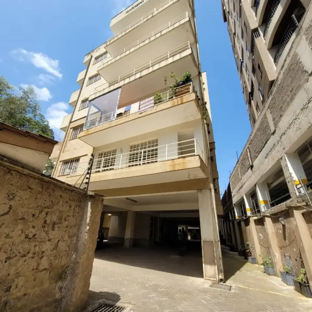 Multi-story residential building with ground-level parking entrance