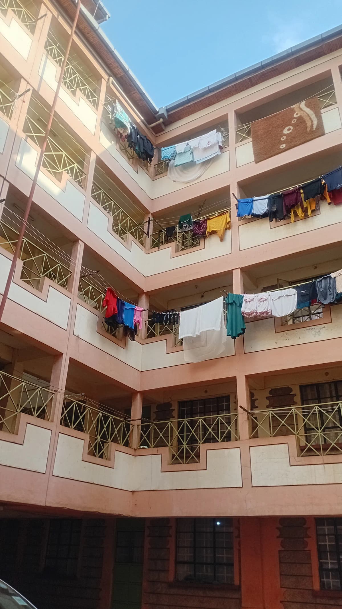 Multi-story residential building facade with balconies and laundry
