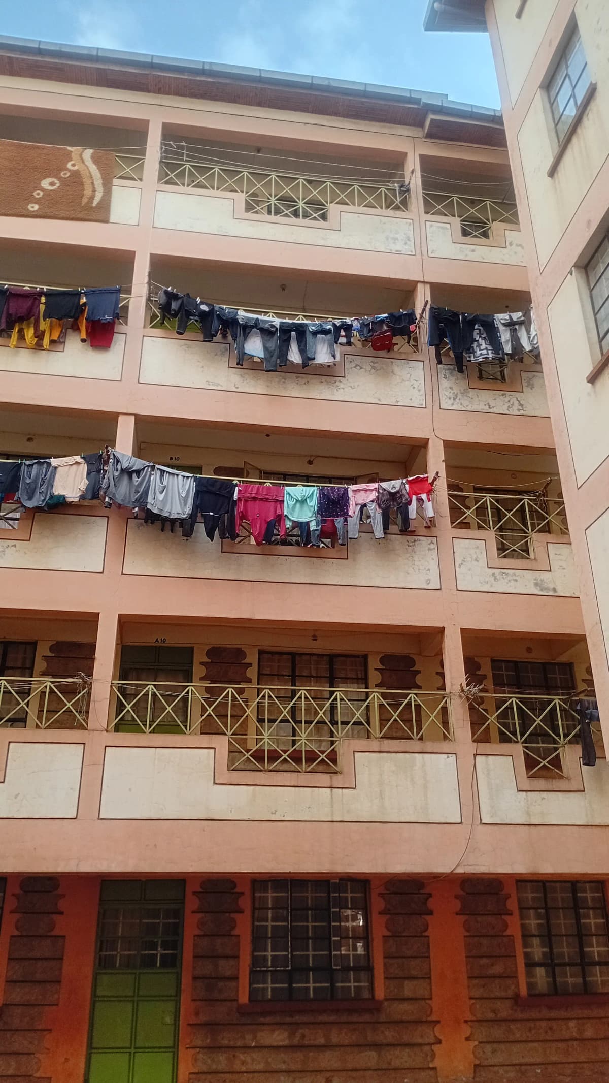 Multi-story residential building facade with balconies and laundry