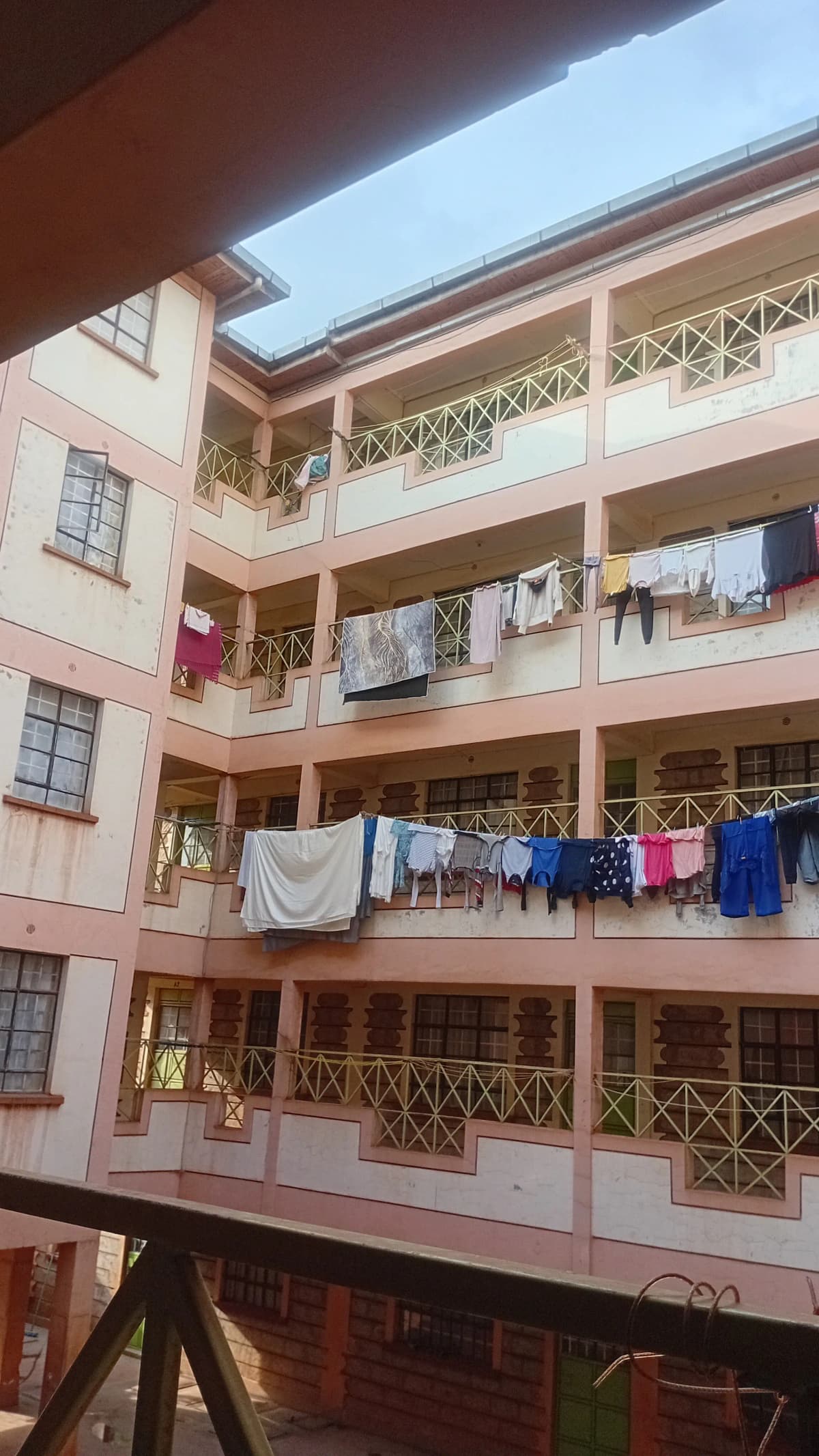 Multi-story residential building facade with balconies and clotheslines