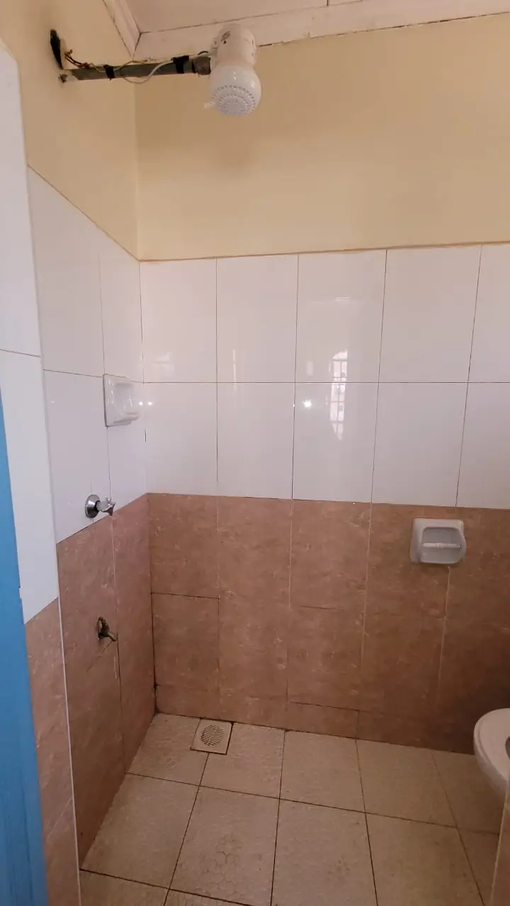 Basic bathroom with brown and white tile walls