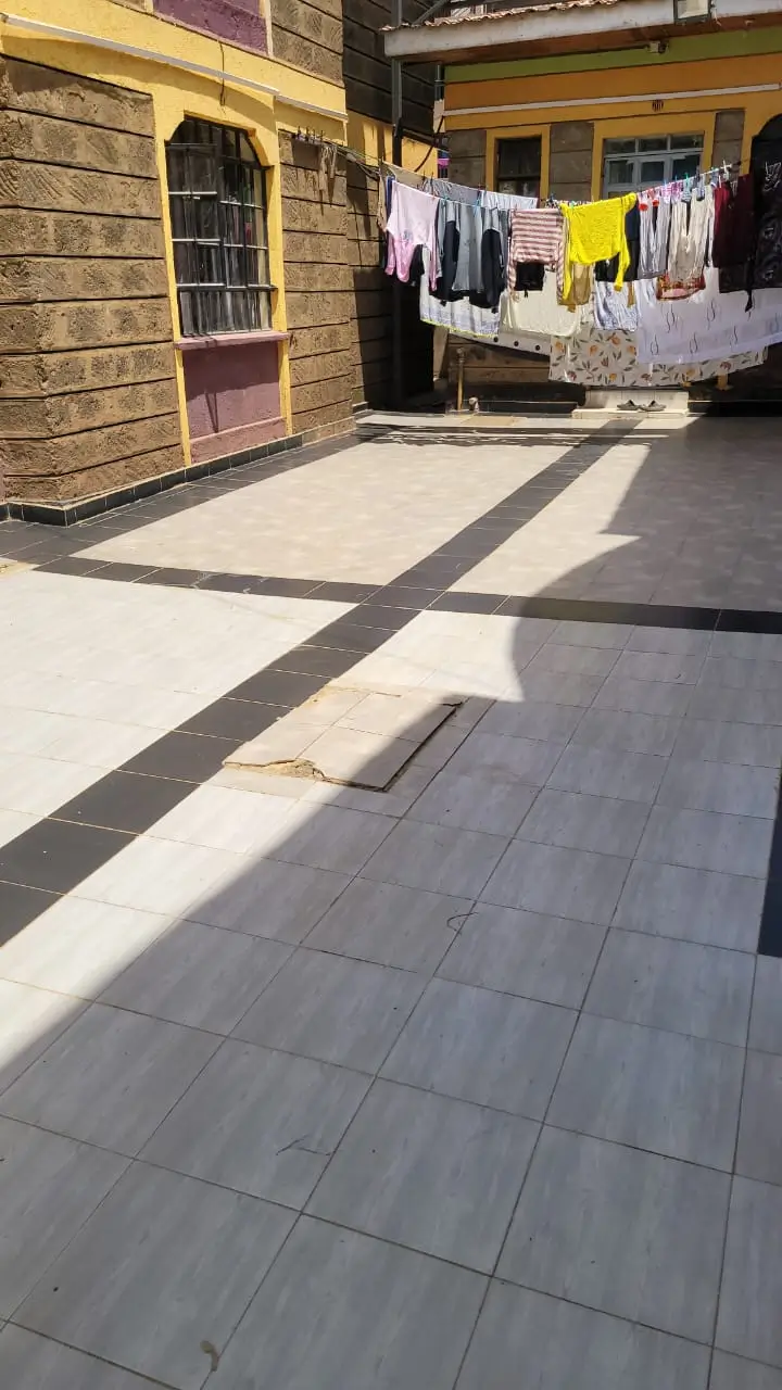 Compound courtyard with paved floor and laundry lines