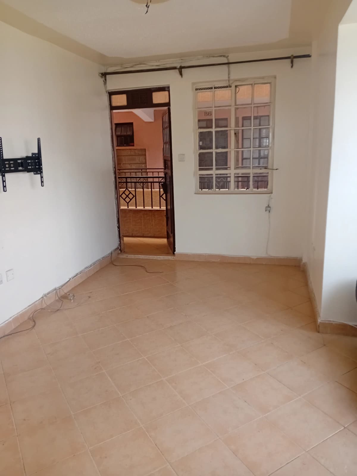 Spacious empty living room with terracotta tile flooring