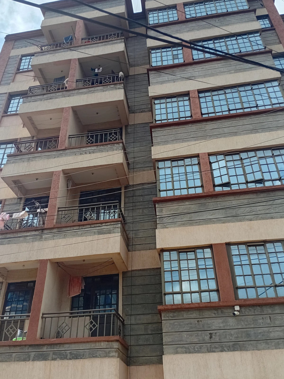 Multi-story residential building facade with balconies and windows