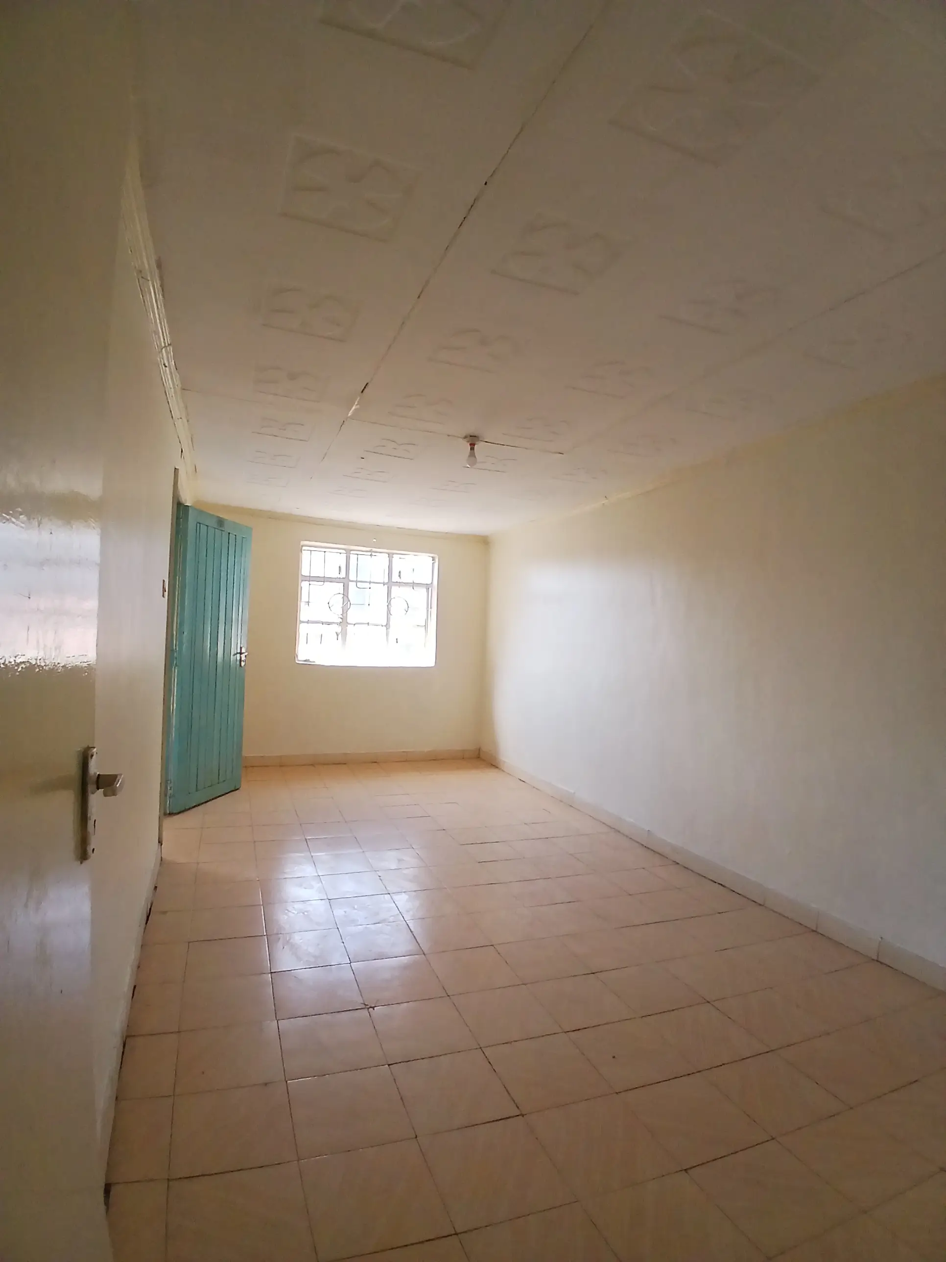 Unfurnished bedroom with tiled floor and window