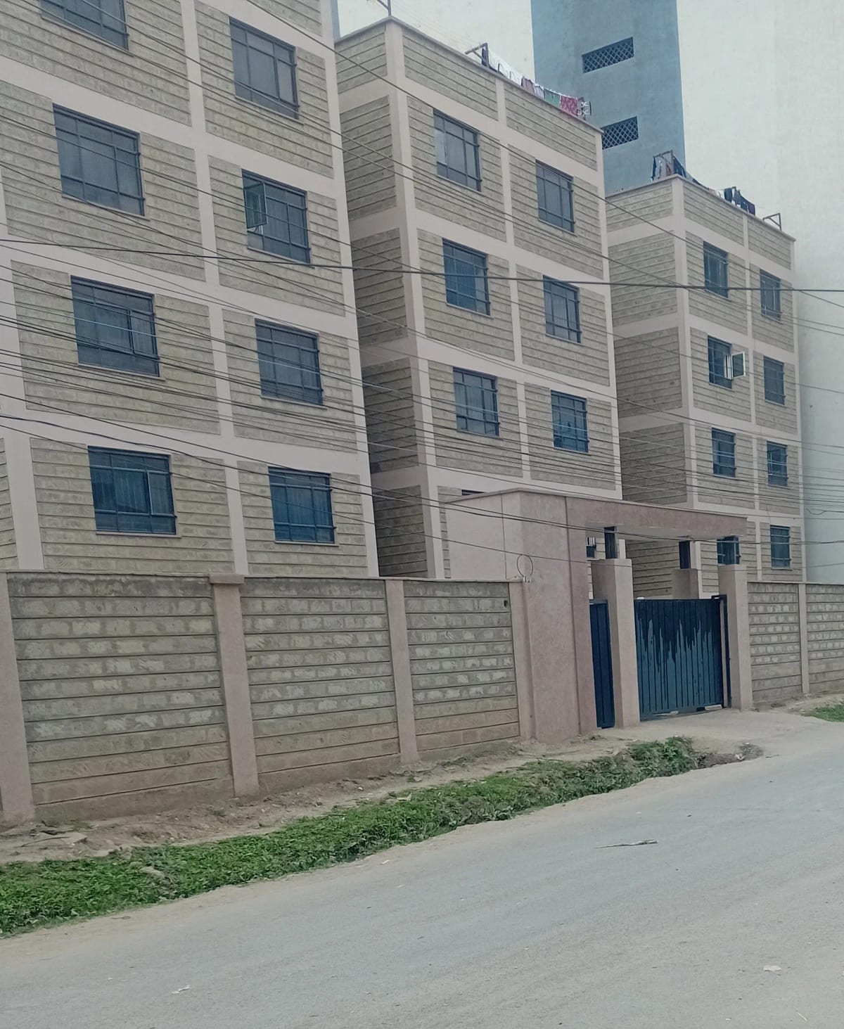 Modern apartment building facade with concrete boundary wall