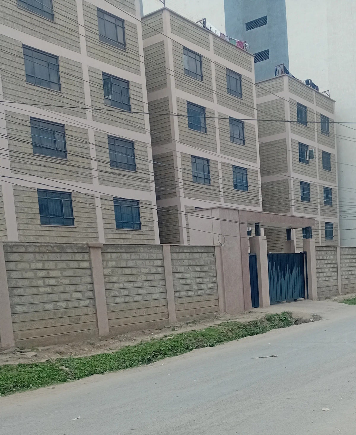 Modern apartment building facade with concrete boundary wall