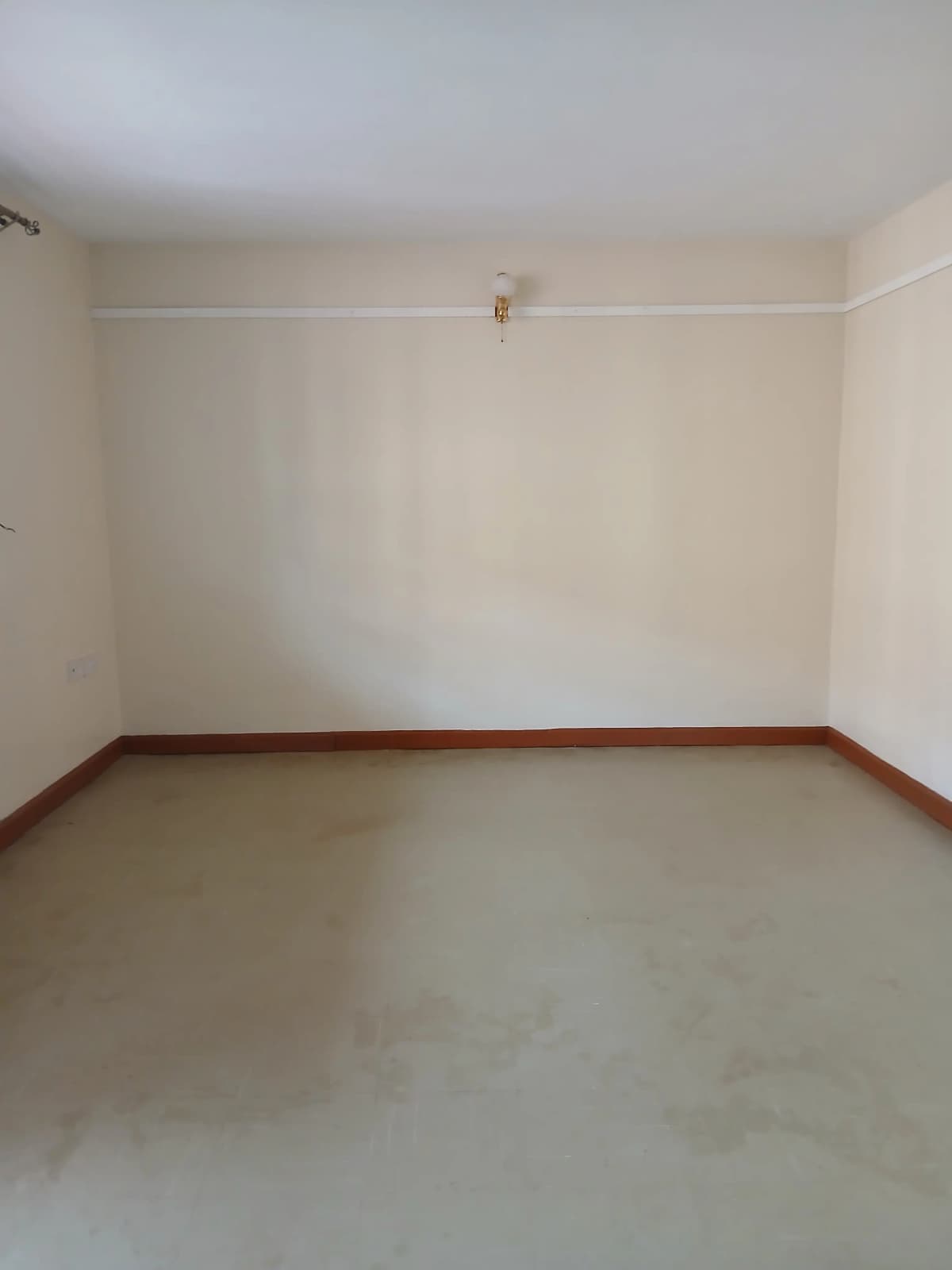 Empty room with white walls and brown beam