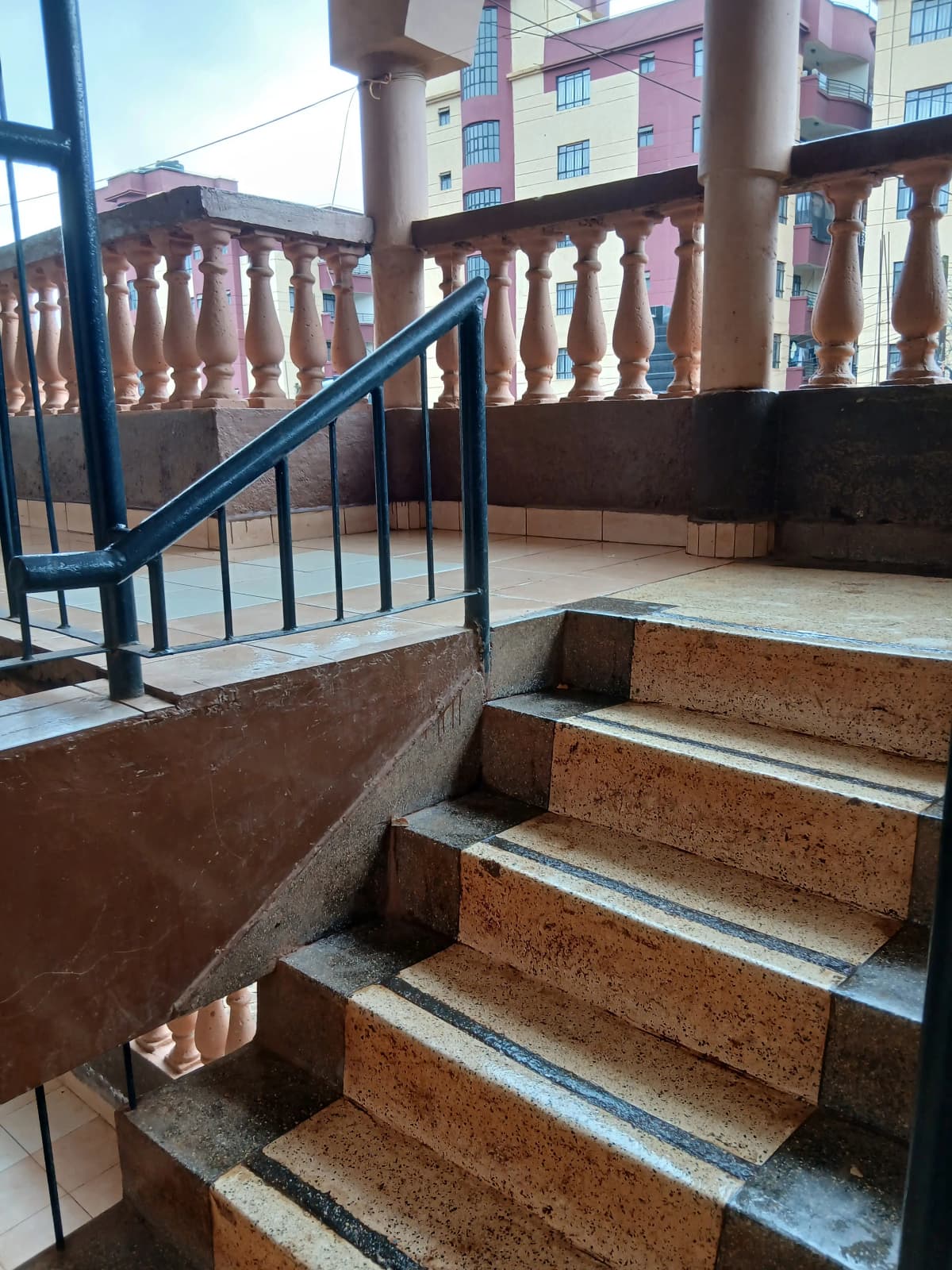 Building corridor with staircase and blue metal railing