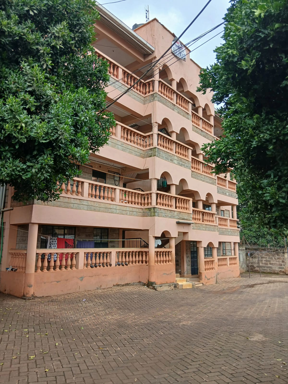 Multi-story terracotta residential building facade with balconies