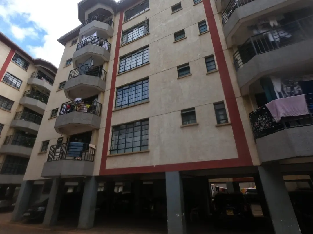 Modern residential building facade with red and beige trim