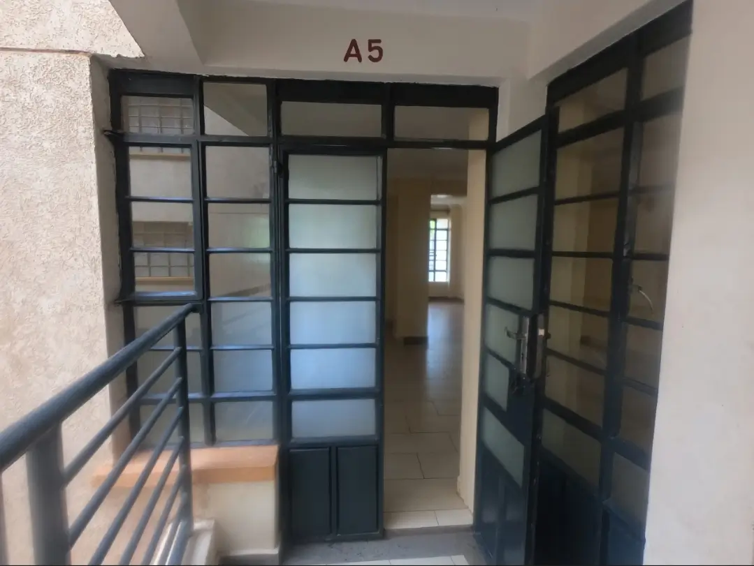 Building corridor with glass partitions and metal railing