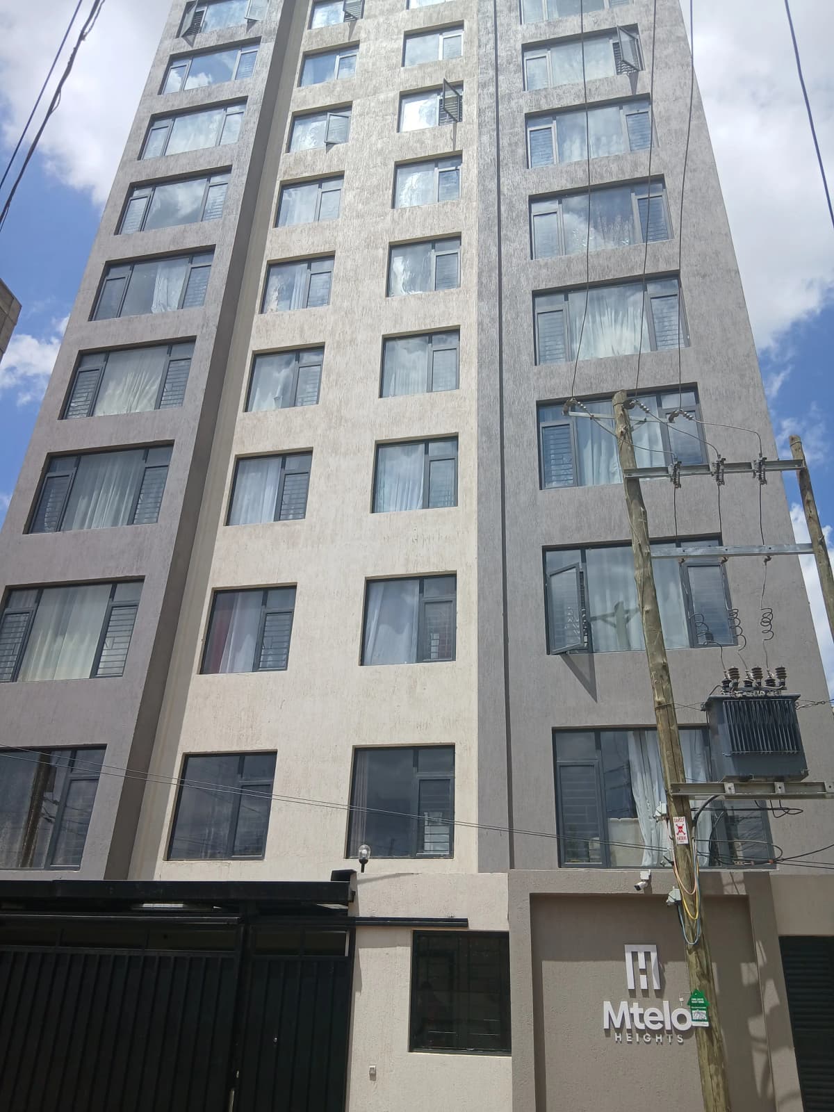 Multi-story residential building facade with regular window grid