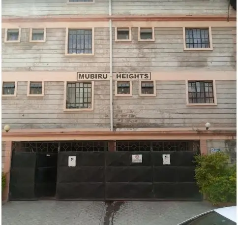 Mubiru Heights apartment building facade with ground-floor parking gates