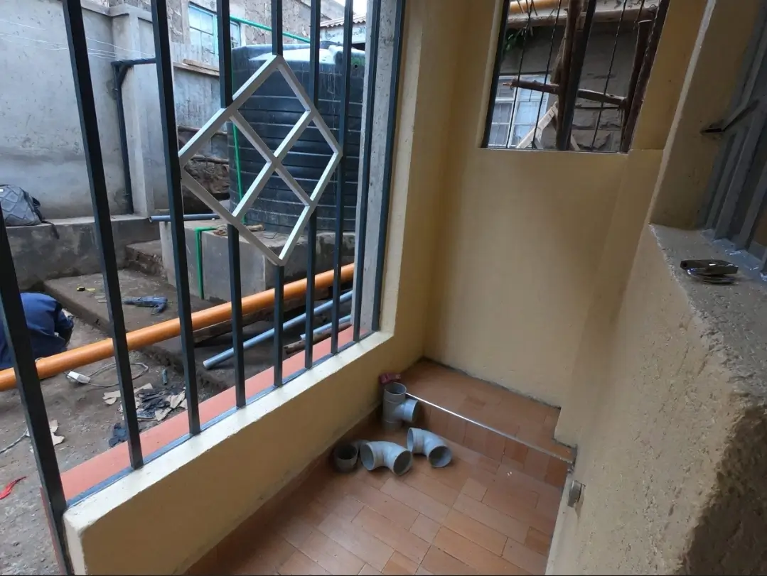 Building entry area with security gate and tiled flooring