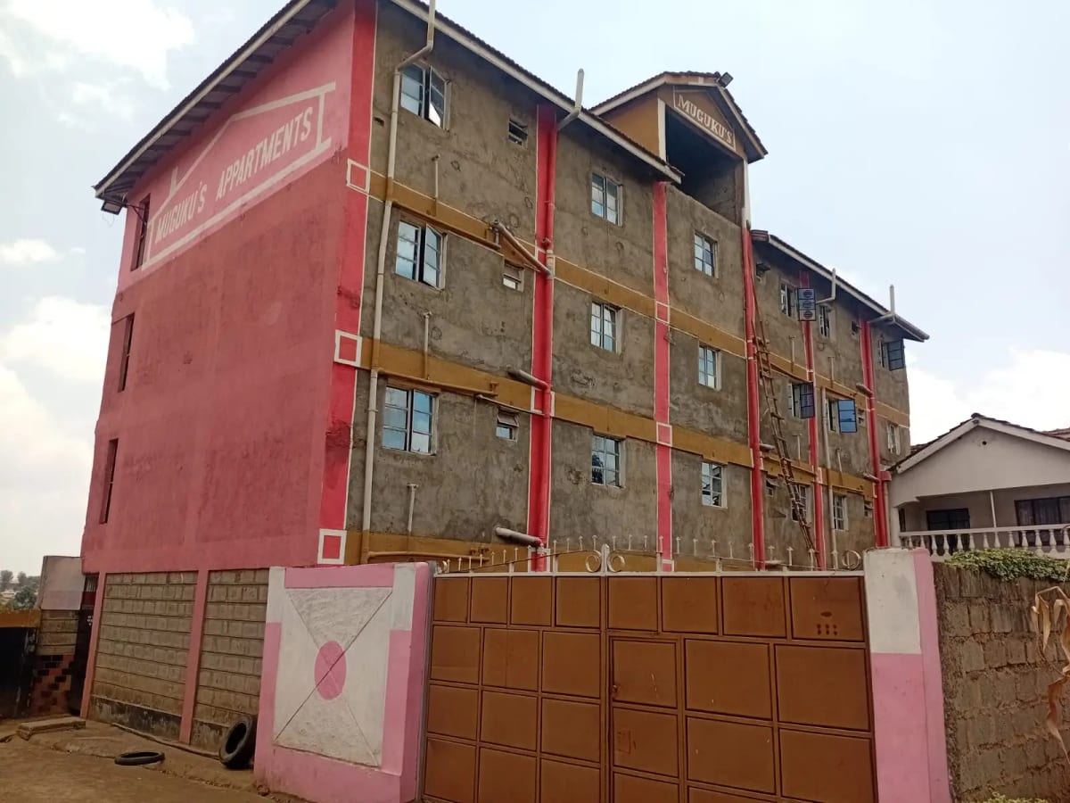 Multi-story residential building facade with red and brown paint
