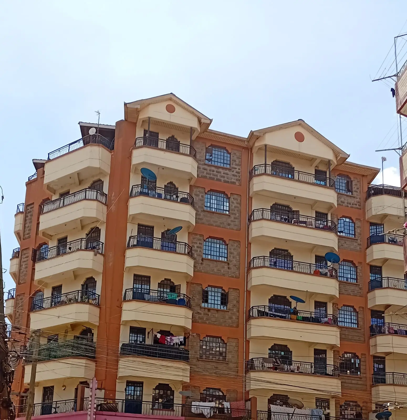 Multi-story residential building with brick and cream facade