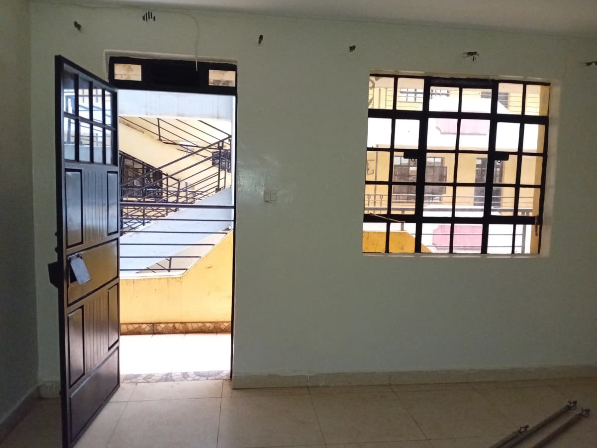 Bright entrance lobby with open door to exterior courtyard