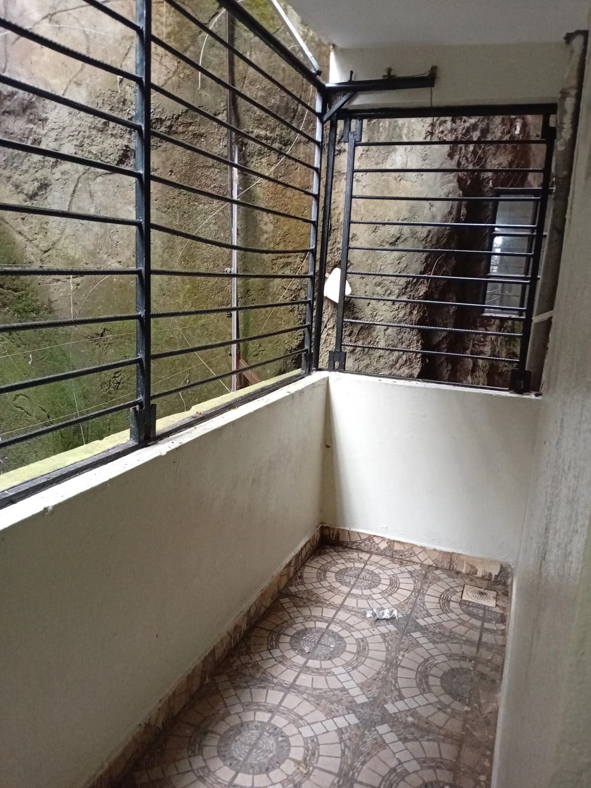 Compact balcony with metal railings and tiled flooring