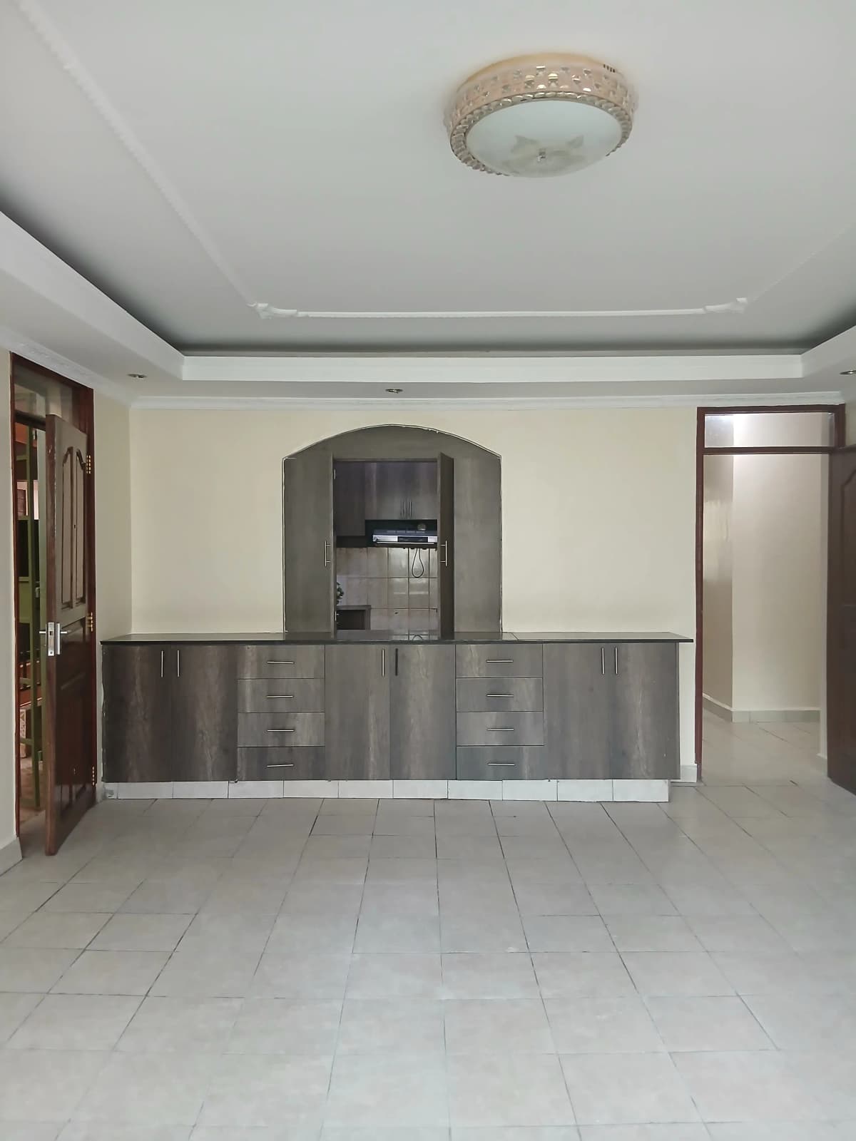 Open-plan living space with integrated kitchen counter and storage