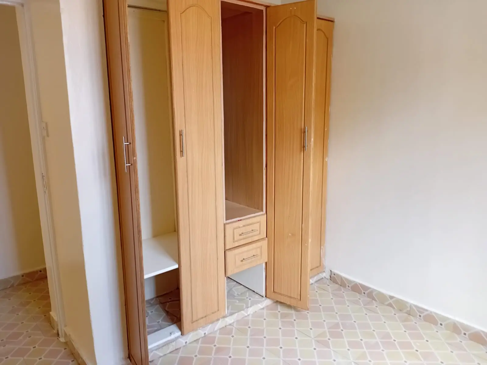 Bedroom with wooden wardrobe and mirrored doors