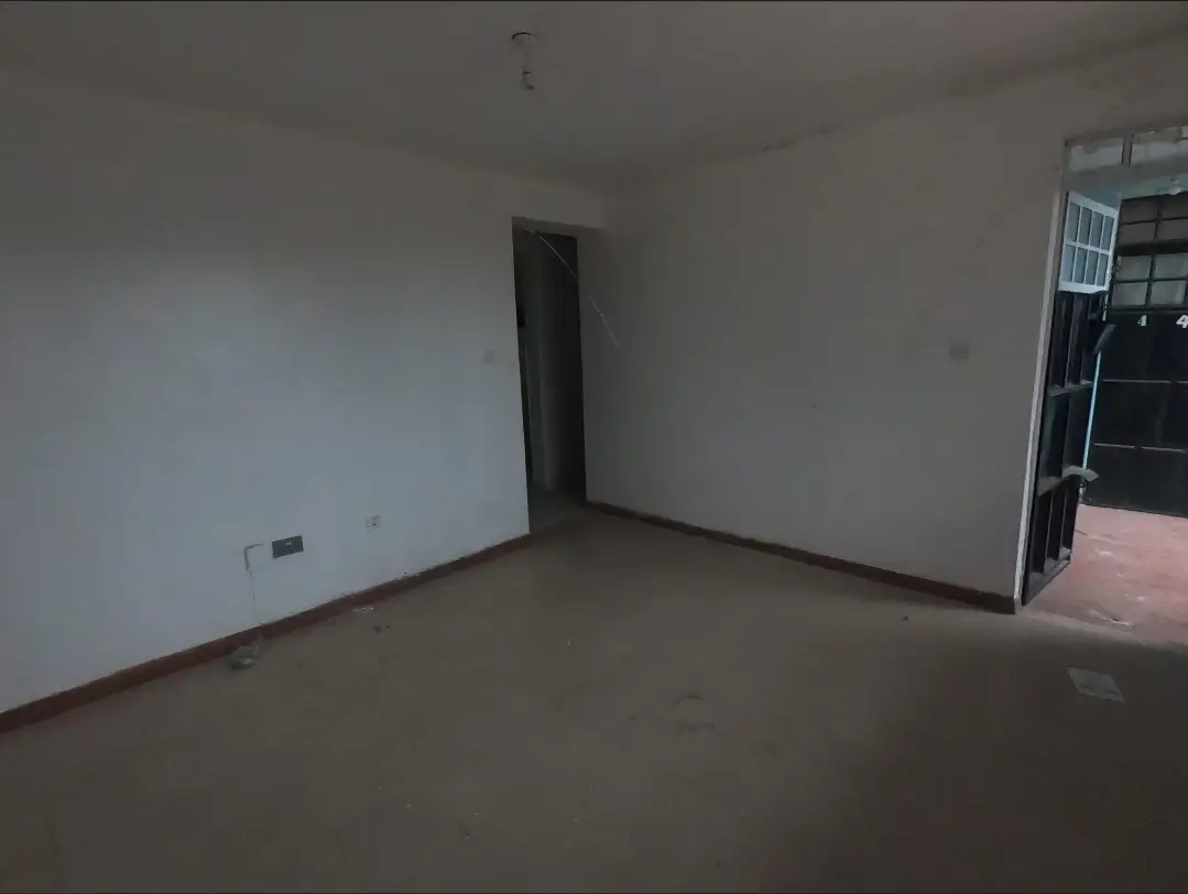 Empty living room with polished concrete floor and glass doors