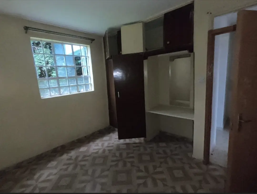 Bedroom with built-in wardrobe and window