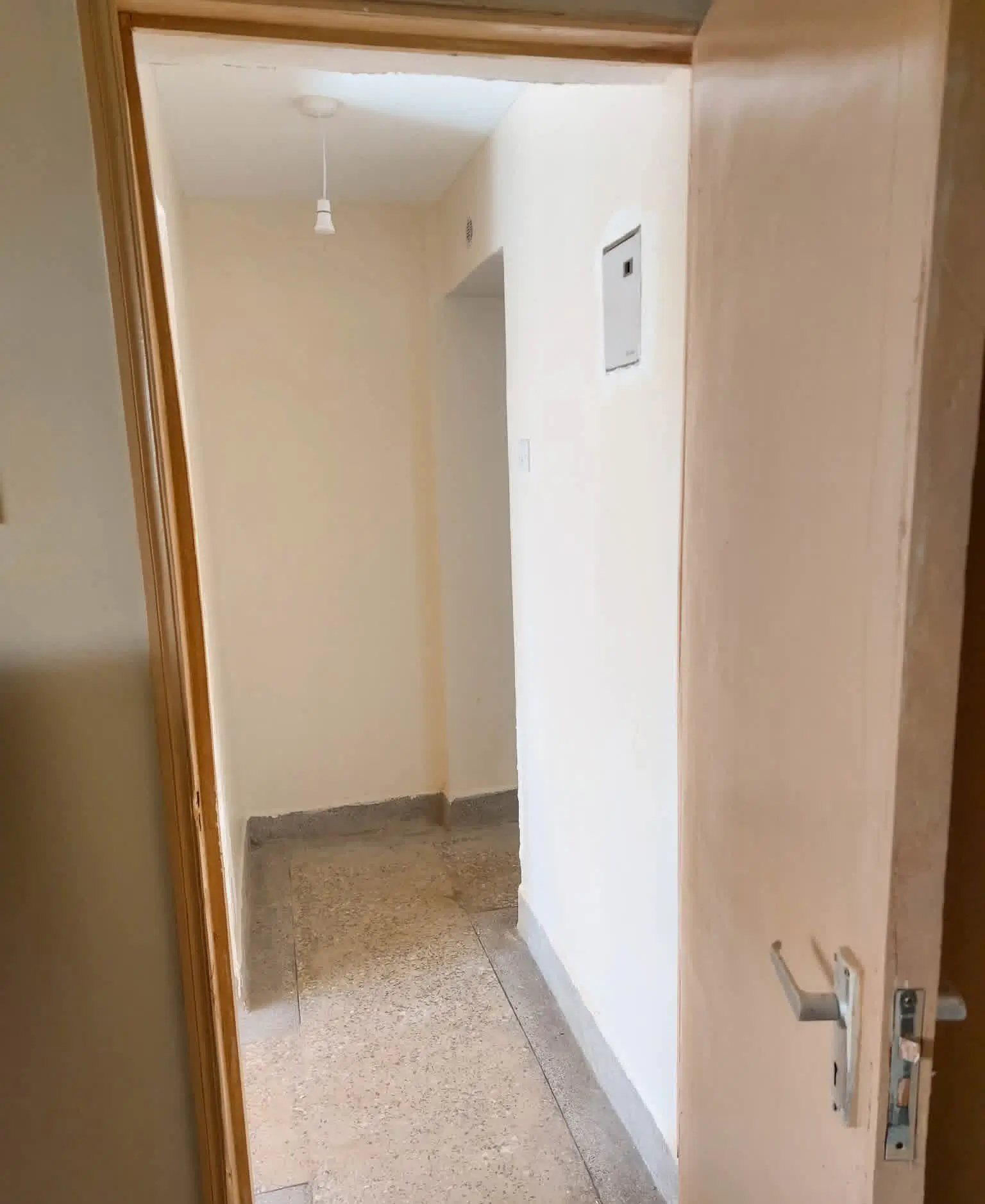 Small utility storage room with concrete floor and bare walls