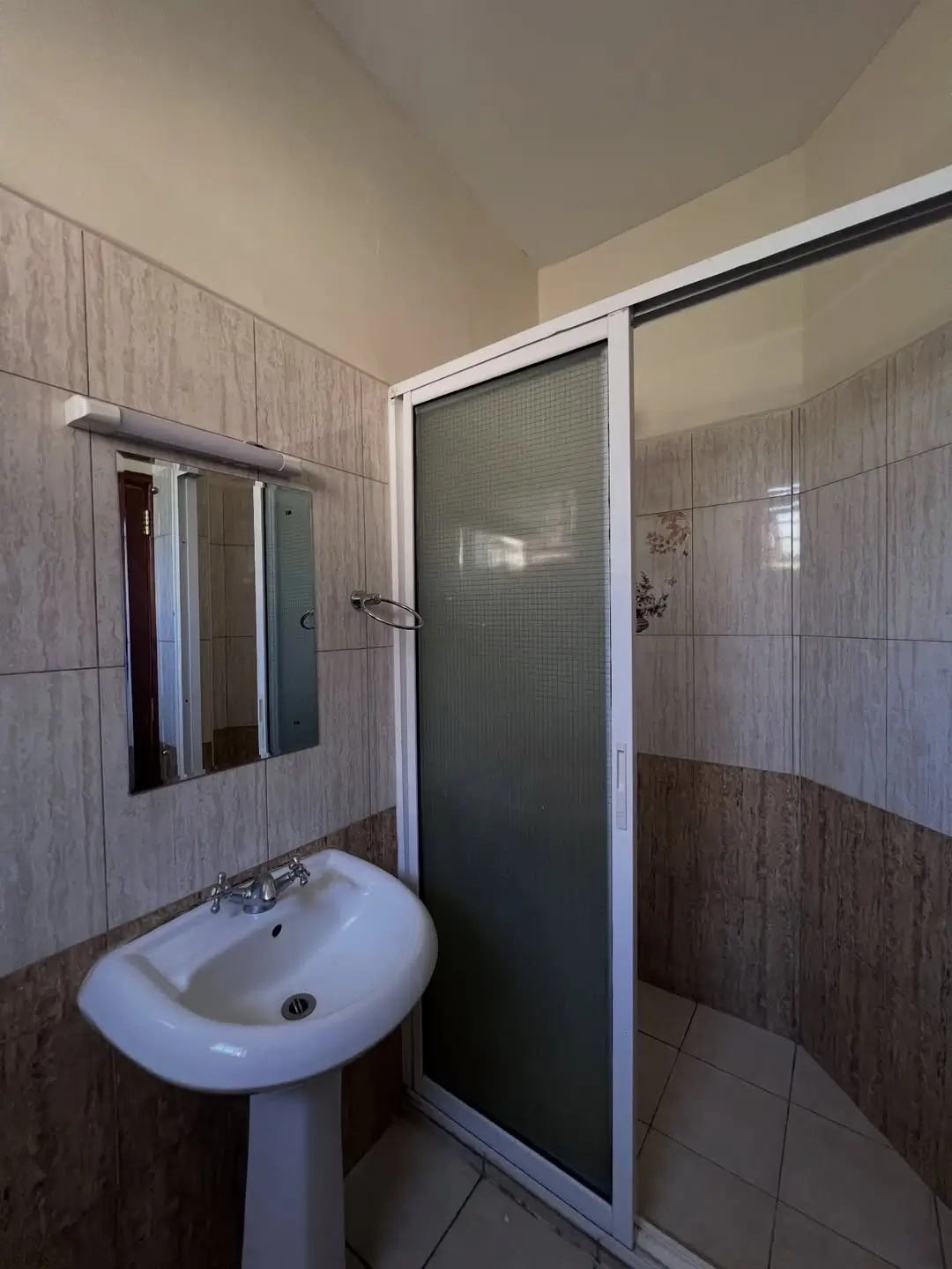 Bathroom with pedestal sink and shower enclosure