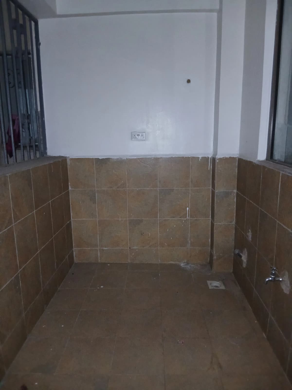 Bathroom with brown tile walls, under construction