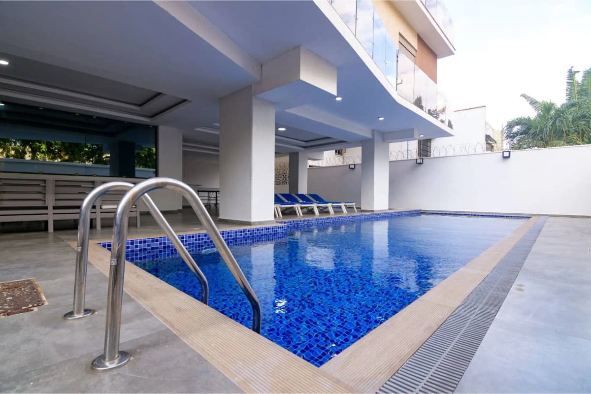 Residential swimming pool with stainless steel ladder and deck