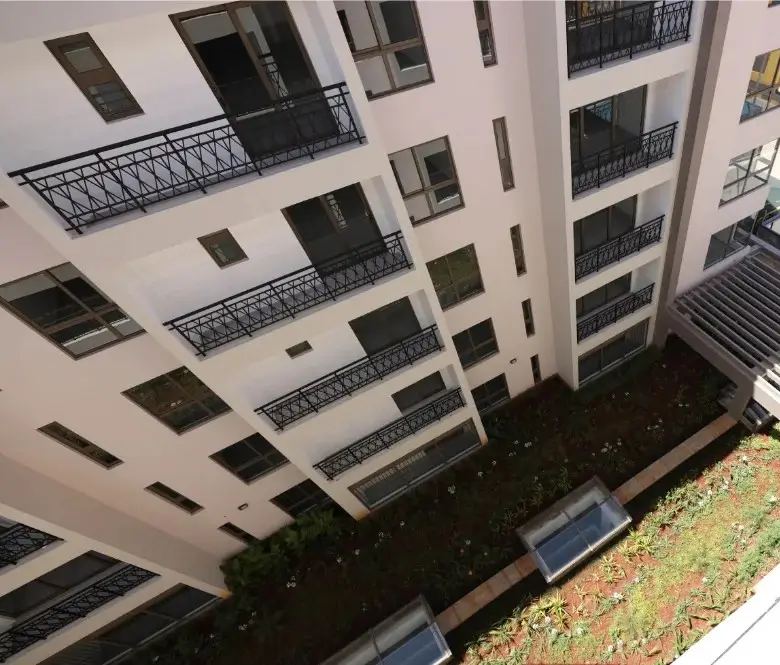 Modern apartment building with multiple balconies and courtyard