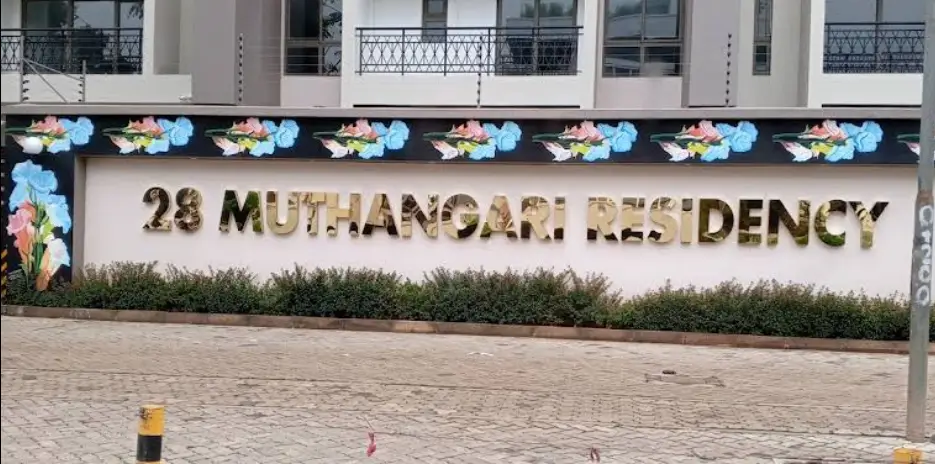 Building facade with signage and decorated compound entrance