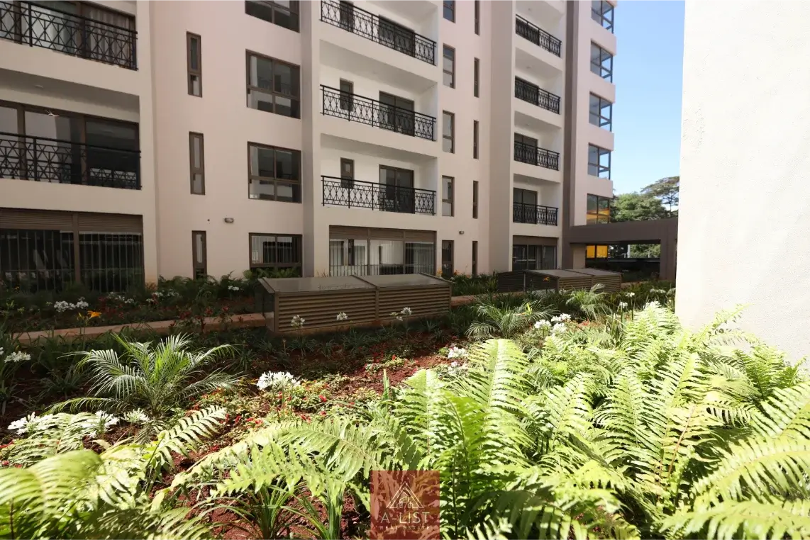 Lush landscaped compound grounds with ferns and tropical plants