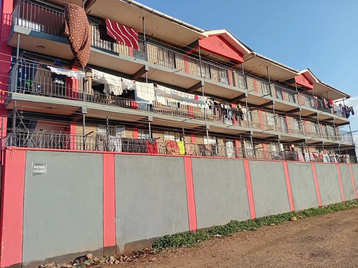 Multi-story apartment building facade with red and gray exterior