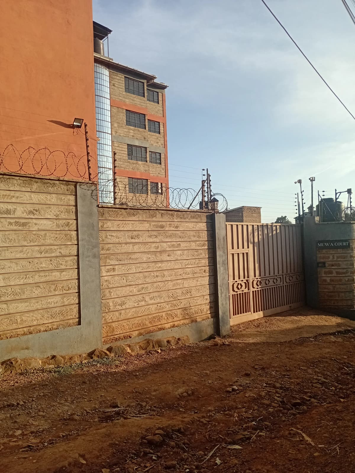 Residential building compound with wooden perimeter fence and gate