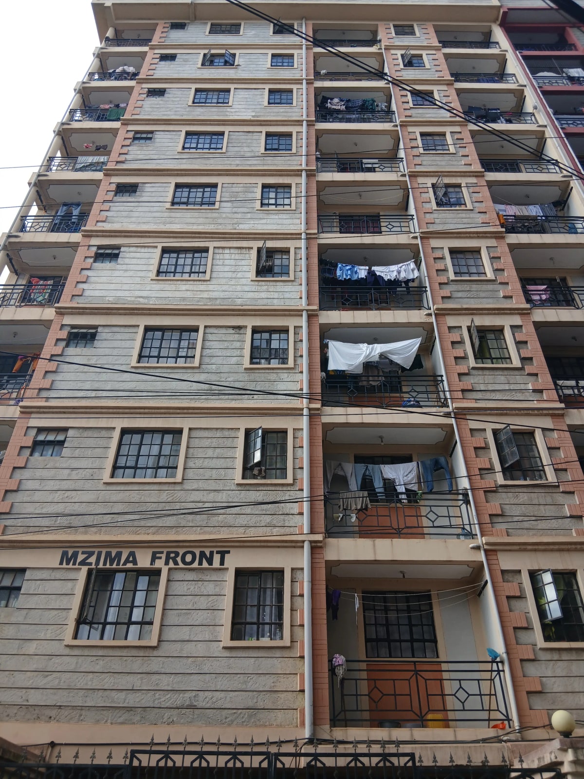 Multi-story residential building facade with balconies and windows