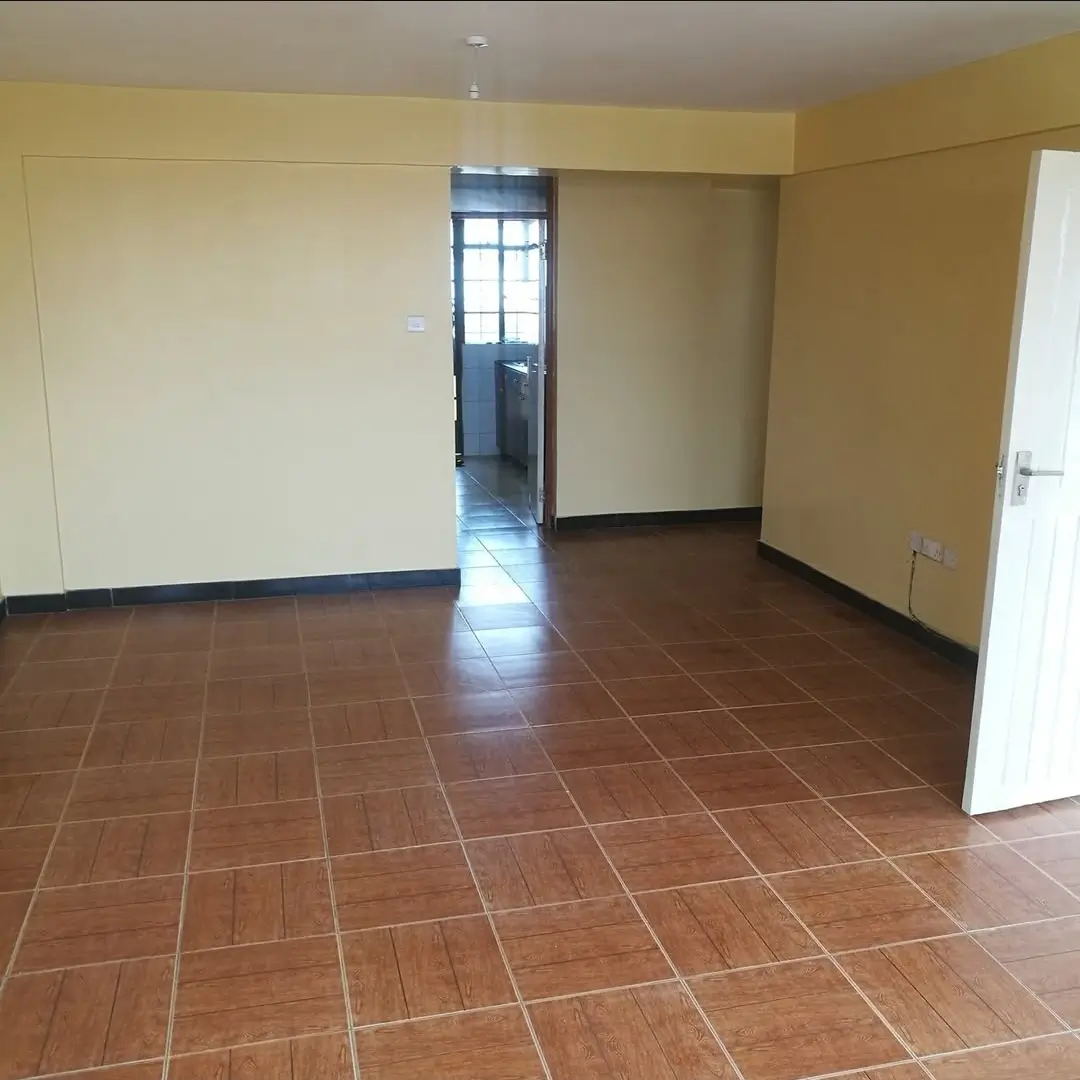 Spacious empty living room with terracotta tile flooring