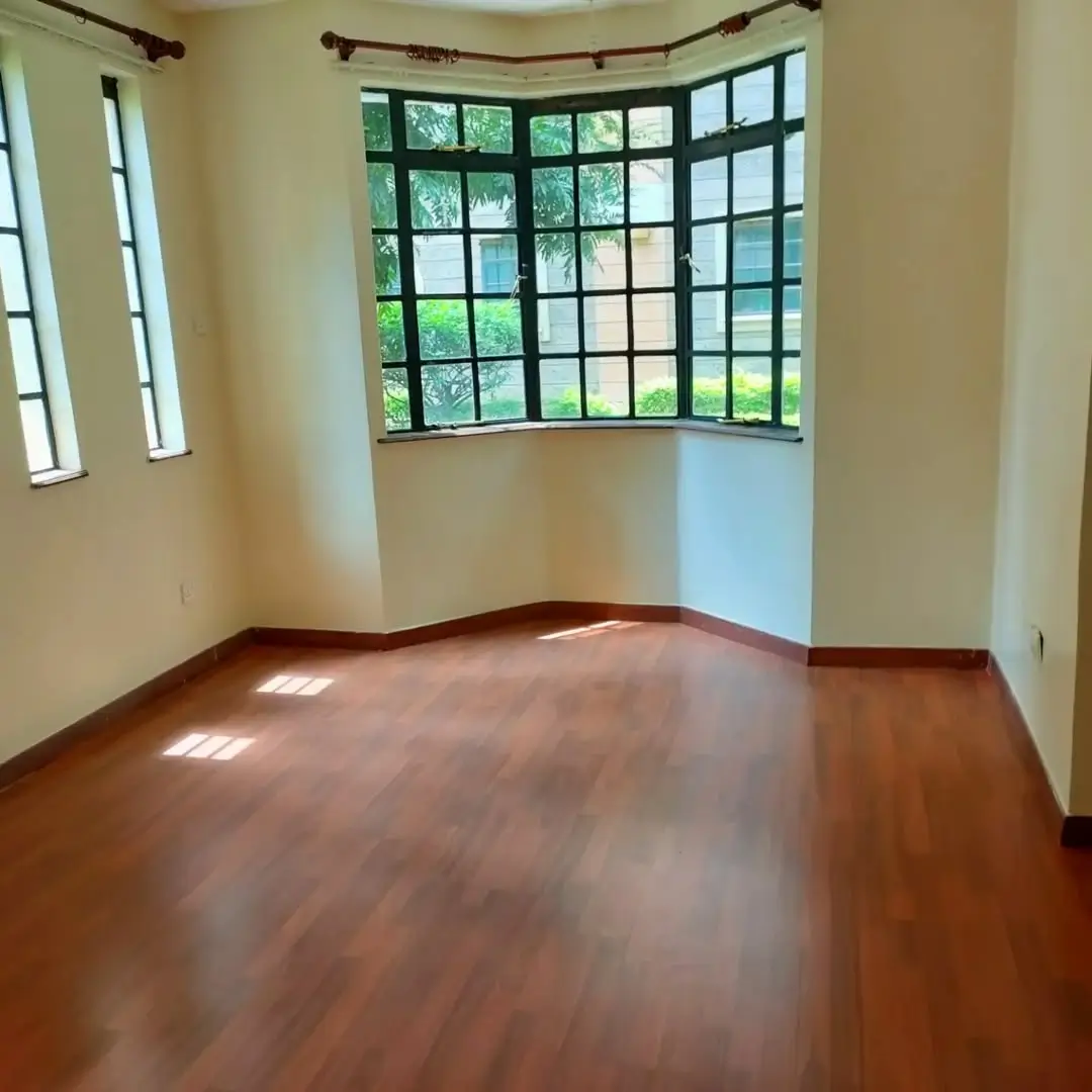 Spacious living room with curved bay windows overlooking garden
