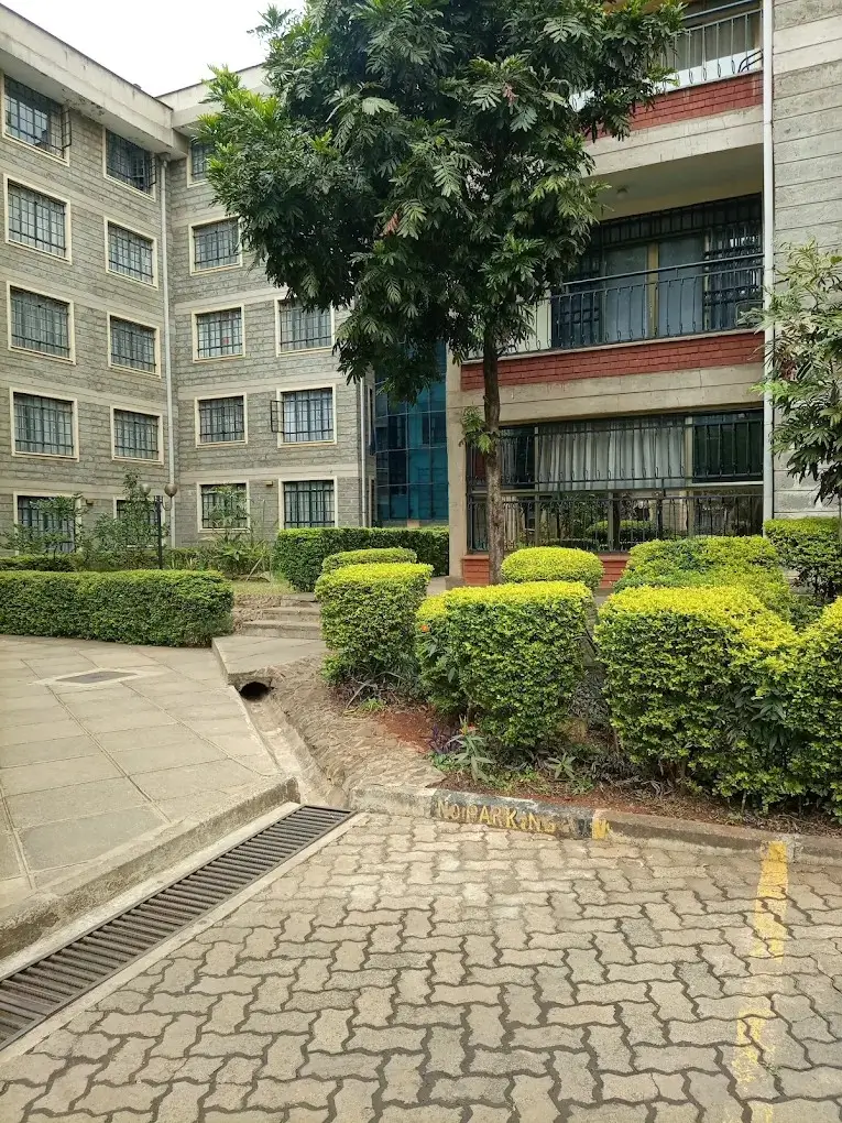 Manicured compound grounds with hedges and landscaping