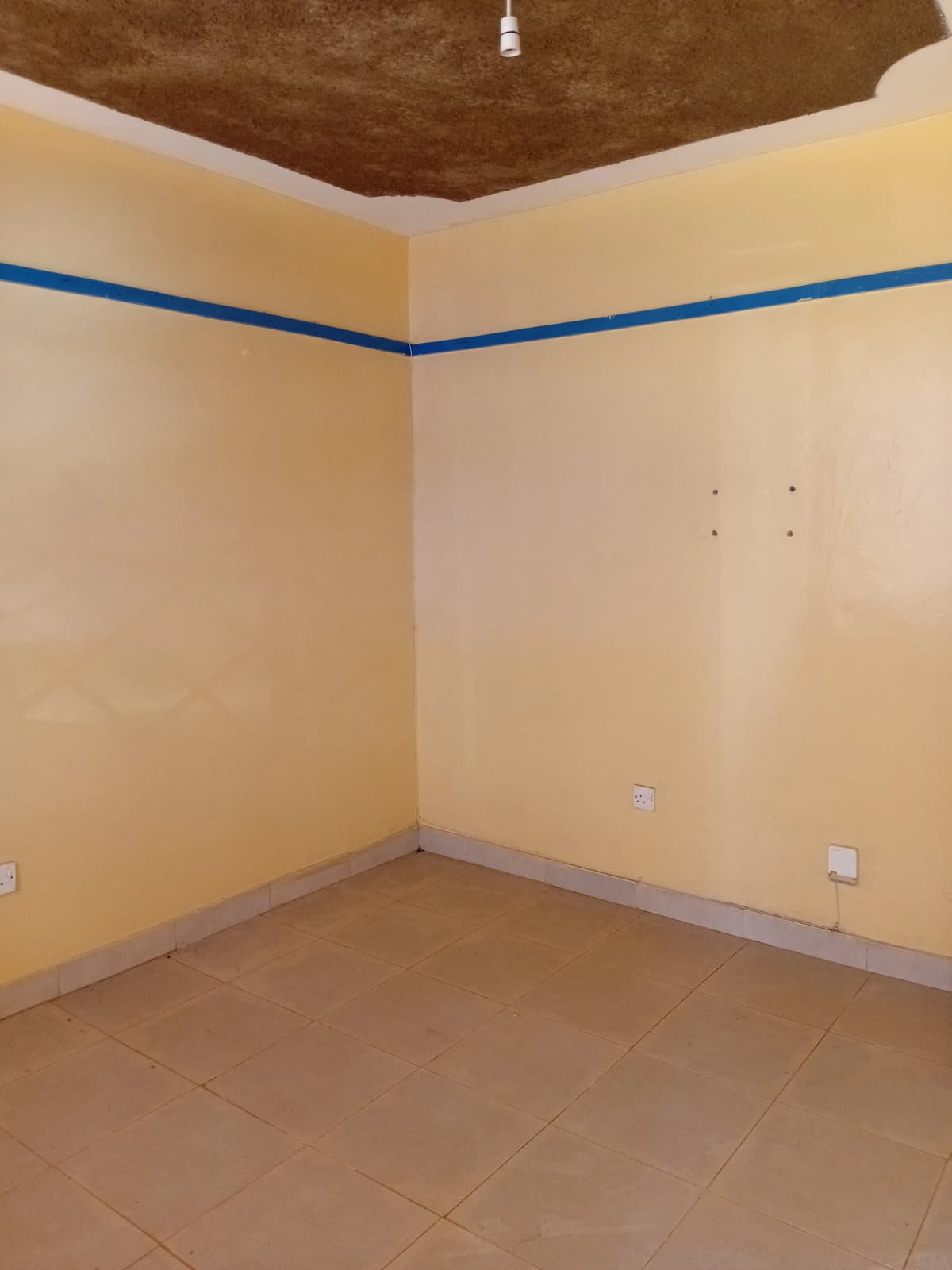 Empty bedroom with yellow walls and brown ceiling